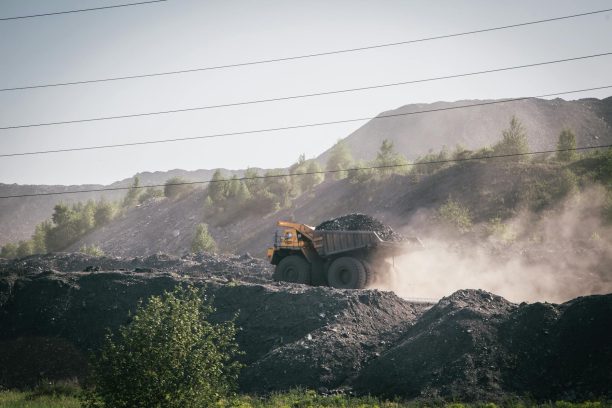 truck carrying stones on construction site in mountains