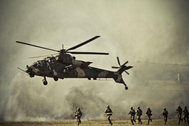 military helicopter and soldiers in action